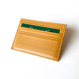 Flat leather card holder from paris with a card inside for comparaison